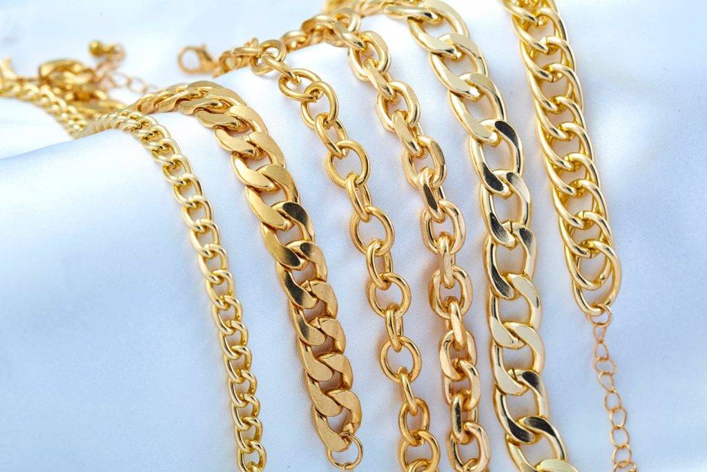 Gold plated jewellery - yellow gold necklaces and chains on white background