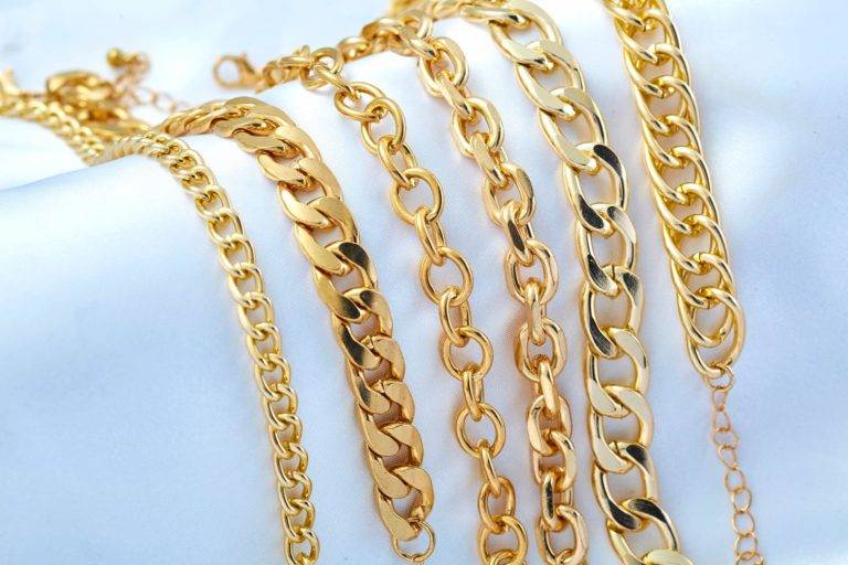 Gold plated jewellery - yellow gold necklaces and chains on white background